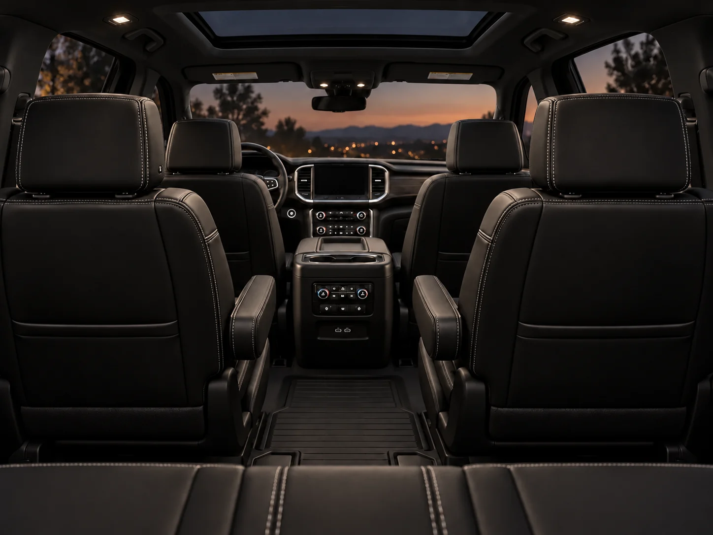 Suburban interior viewed from the third row, with black leather seats and a sunroof