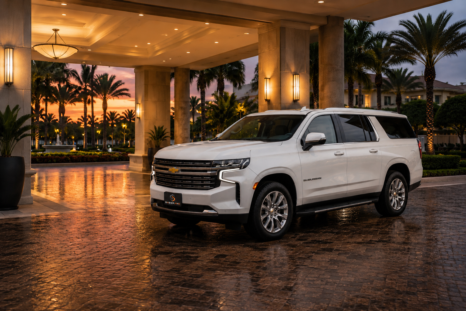 White Chevrolet Suburban at luxury hotel entrance