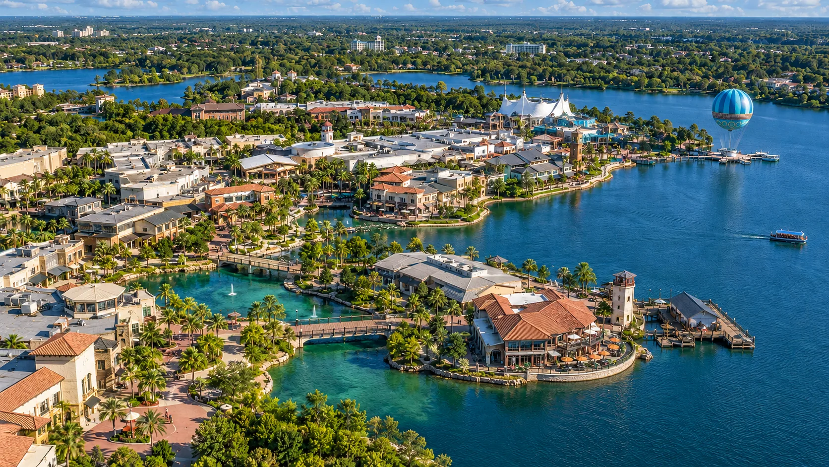 Aerial view of Disney Springs, its waterfront and blue tethered balloon
